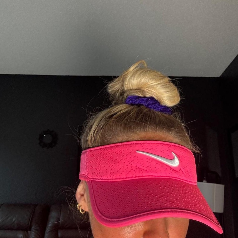 Pink Nike visor with white swoosh